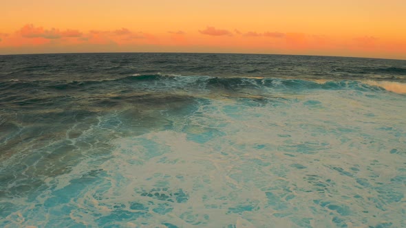 Colorful Ocean Wave. Sea Water in Crest Shape. Sunset Light and Beautiful Cloudscape Sky