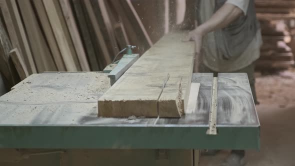 Closeup of Wood Plank on Woodworking Machine in Carpentry Workshop