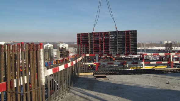 Tower Crane Carries Concrete Plates Along Construction Site