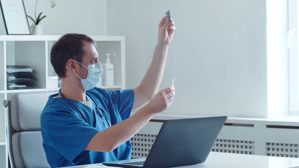 Professional medical doctor working in hospital office using computer technology.