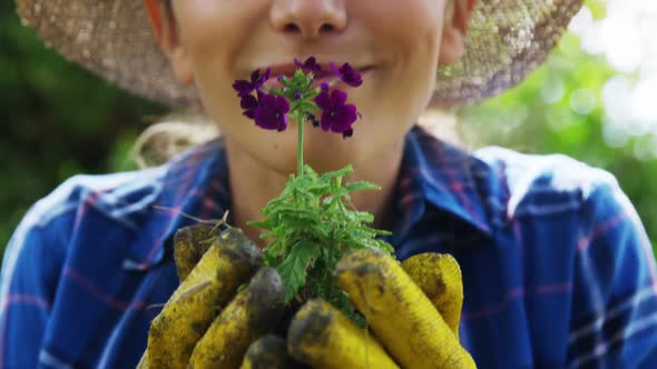 Woman smelling flower in garden