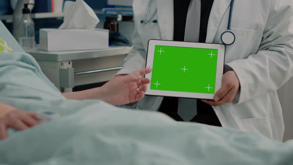 Close Up of Horizontal Green Screen on Tablet in Hand of Doctor