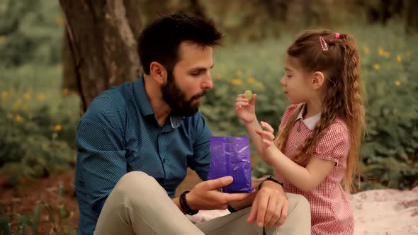 Daughter Kid With Father Eating Sweets. Daughter With Cheerful Father Eat Candy.