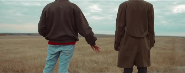 Romantic Couple Holding Hands on Autumn Field