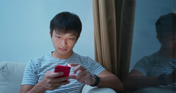 Man use of mobile phone online at night