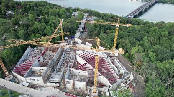 Aerial View Construction of a New Building with High Tower Cranes in Green Area