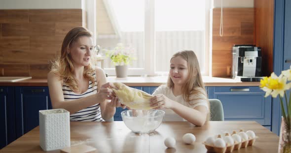 Mother and Daughter Baking Cooking Together in the Kitchen at Home