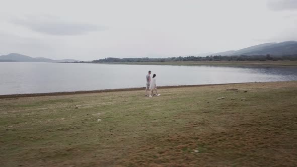 Young couple on the beach in cloudy weather