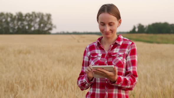 Woman Technologist Agronomist with Tablet Computer Sends Data to the Cloud