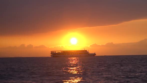 Ferry Floating at the Cloudy Sunset 