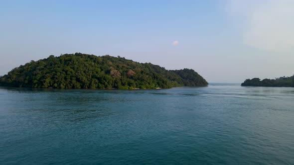 Uninhabited tropical island near coastline of Indonesia, aerial drone view