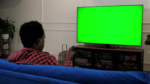 Green Screen TV African American Man Looking at TV Chroma Key Mock Up Display