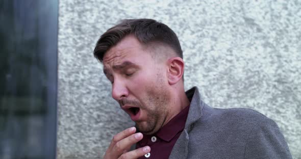 Portrait of Man Sneezes with Heavy Breathing Outdoors
