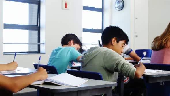 Students doing homework in classroom
