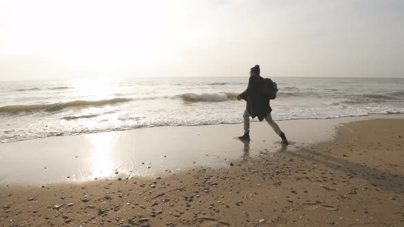 Thoughtful Lone Man Look at Sunrise Wave Ocean Horizon and Throw Stones to Water