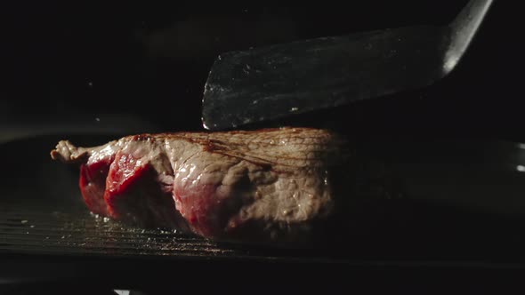 Chief Cooking A Beef Steak On A Grill