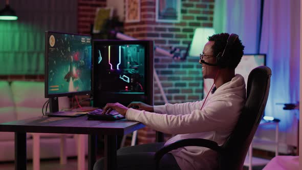 African American Man Streaming Fast Paced Multiplayer Space Shooter Tournament Using Pc Gaming Setup