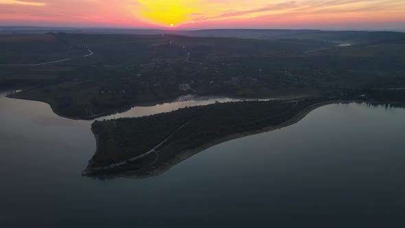 Aerial drone view of the Duruitoarea natural reservation at sunset in Moldova. River and village, hi