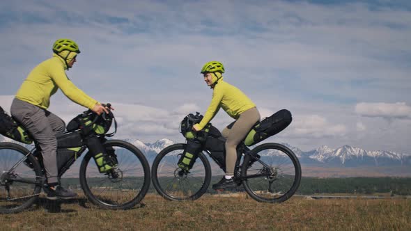 The Man and Woman Travel on Mixed Terrain Cycle Touring with Bikepacking