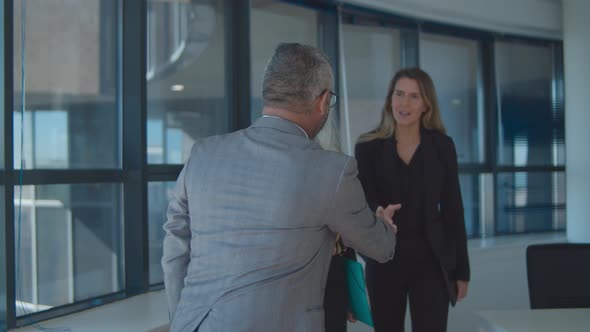 Confident Businessman Meeting Female Partners in His Office