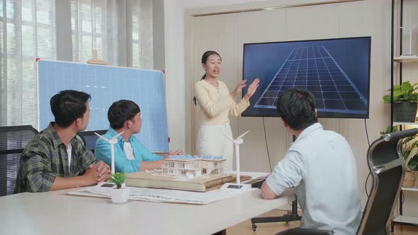 Asian Woman Engineer Presenting About The Work Of Solar Cell To Her Colleagues At The Office
