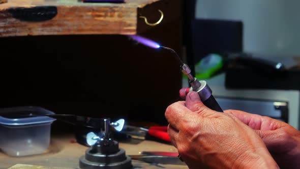 Craftswoman using blowtorch