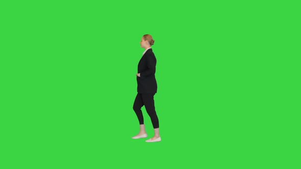 Gorgeous Blond Fashionable Businesswoman Walking By on a Green Screen Chroma Key