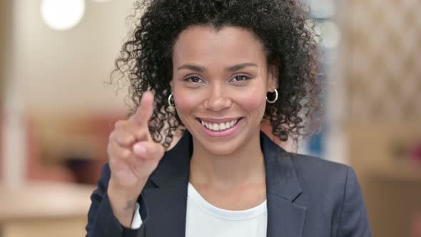 African Businesswoman Pointing with Finger at Camera