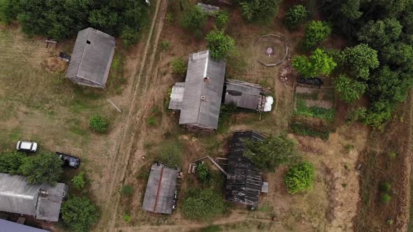 Aerial View of the Village on a Summer Day with Parked Cars and a Country Road Between Old Wooden