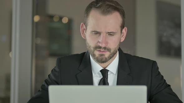 Close Up of Tired Businessman Having Neck Pain in Office at Night 