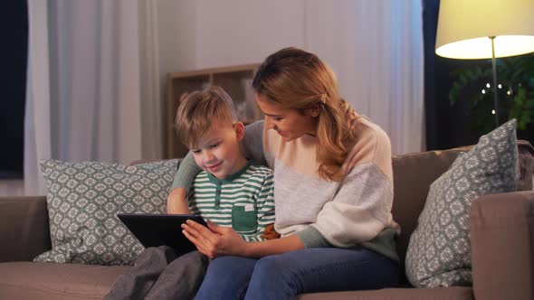 Mother and Son Using Tablet Computer at Home