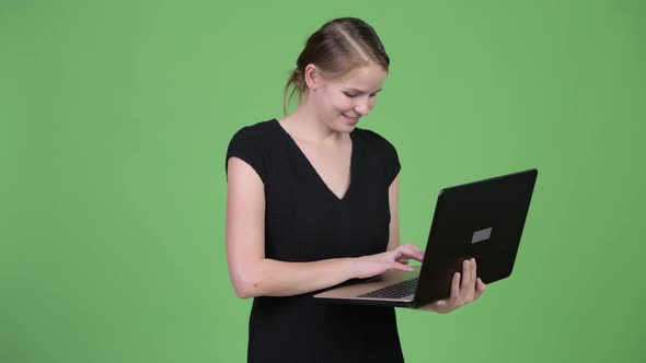 Young Happy Businesswoman Thinking While Using Laptop
