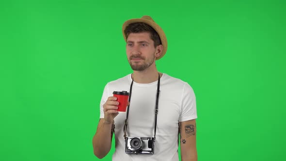 Portrait of Confident Guy Is Enjoying Coffee. Green Screen