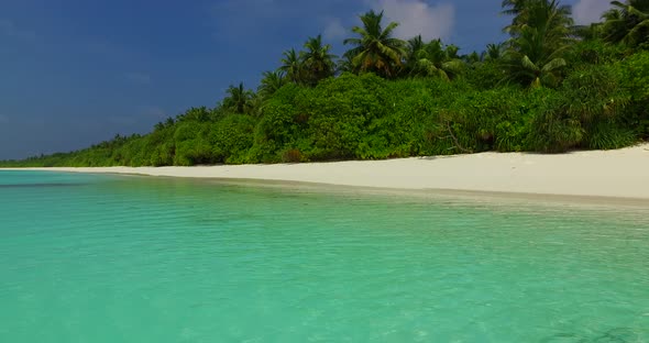 Natural fly over abstract shot of a white sand paradise beach and aqua turquoise water background in