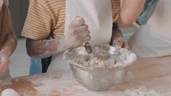 Unrecognizable Boy Kneading Dough