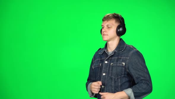 Handsome Guy in Big Headphones Is Running, Chroma Key. Slow Motion