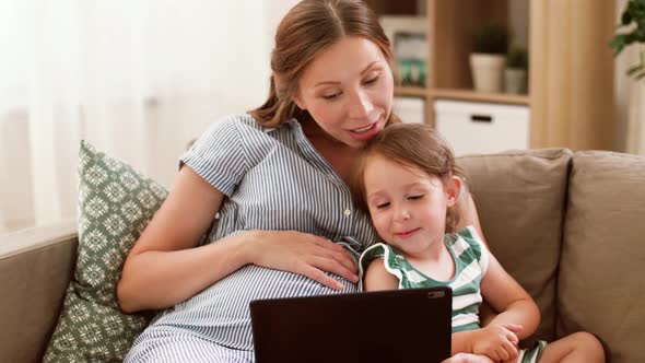 Pregnant Mother and Daughter with Tablet Pc 21