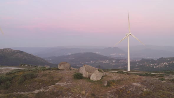 Casa do Penedo drone aerial view in Fafe with wind turbine, Portugal