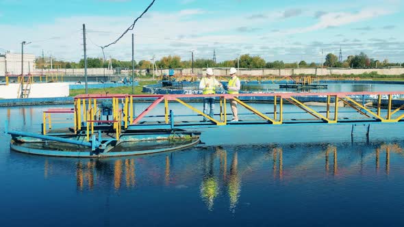 Two Inspectors on the Bridge of the Wastewater Cleaning Plant