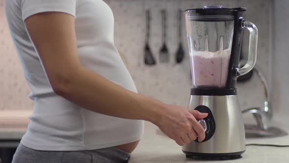 Pregnant Women Preparing a Milkshake Using a Brand in the Kitchen