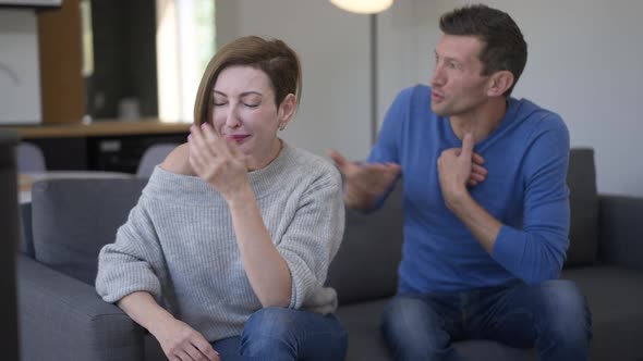 Slim Beautiful Wife Crying As Handsome Husband Gesturing Talking at Background