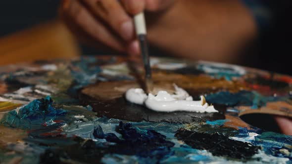 Artist Mixes Paint on the Palette