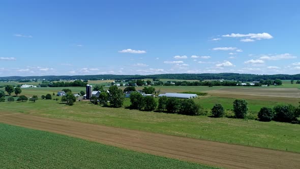 Aerial View of the Farm Countryside With Planted Fields and a Single Rail Road Track