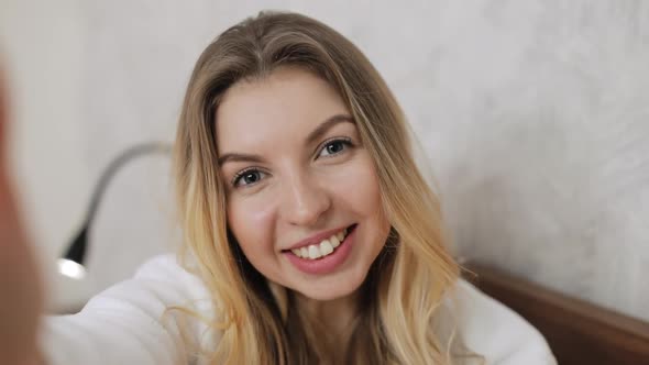 Portrait of Woman Waving to the Camera While Recording Her Blog