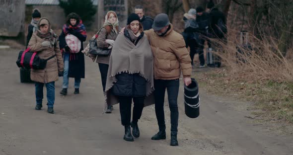 Homeless Refugees Walking On Road While Migrating During War