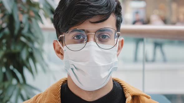 Closeup Portrait Young Man Standing Indoors Looking at Camera Posing Wearing Disposable Medical Mask