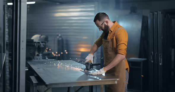 Man Working with Metal at the Workshop