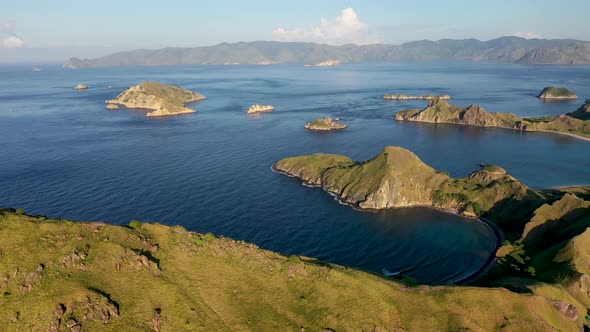 South Padar island east of Komodo Indonesia with calm inlet bays, Aerial pan right wide shot