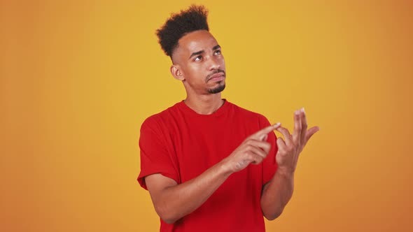 Young Black Man Counting From 1 to 5 Checking Number of People Orange Background