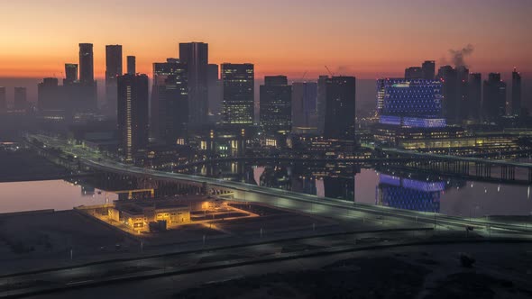 Abu Dhabi City Skyline with Skyscrapers Before Sunrise From Above Night to Day Timelapse